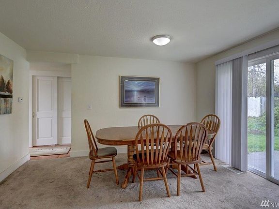 Spacious light filled dining room with sliding glass doors to the patio.
