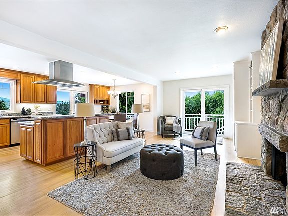 Open and flowing floor plan is flooded with natural light from the abundant windows.