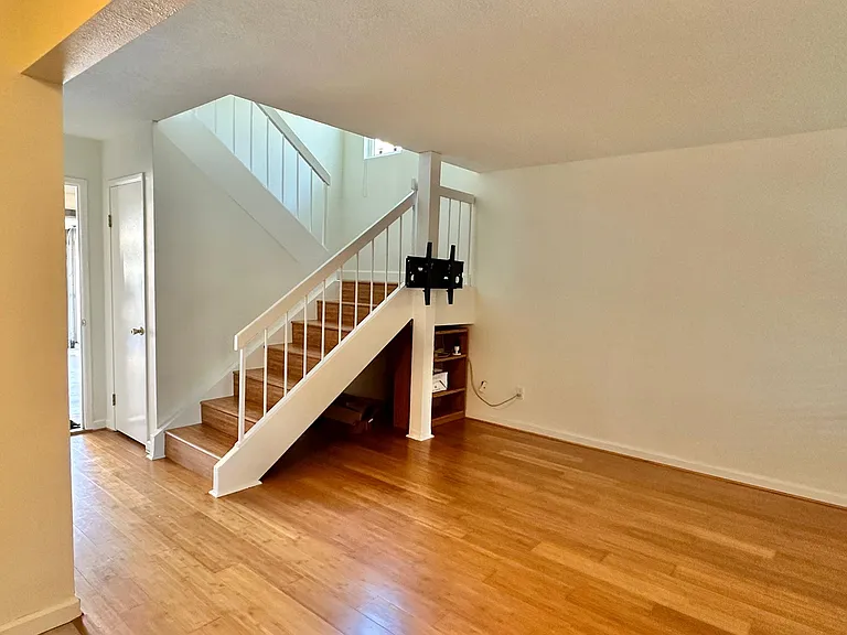 There is a storage closet under the stairs. Guest bath across the hallway from the stairs.