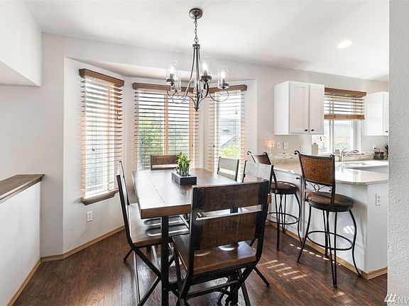 The kitchen and dining room are open and full of natural light! Notice the new light fixture in the dining room! 