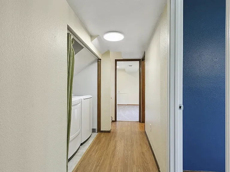Hallway on lower level where the washer and dryer are located.