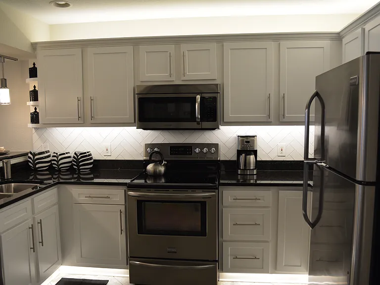 Select units have tile backsplashes and under cabinet & over cabinet lighting