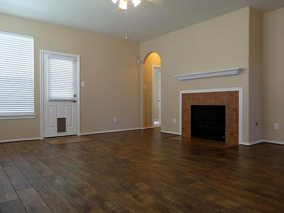 The living room features a cozy gaslog fireplace and access to the backyard.