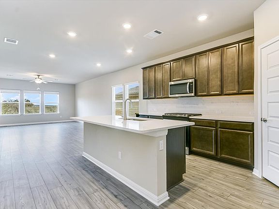 Enjoy a home-cooked meal in this kitchen and dining area.