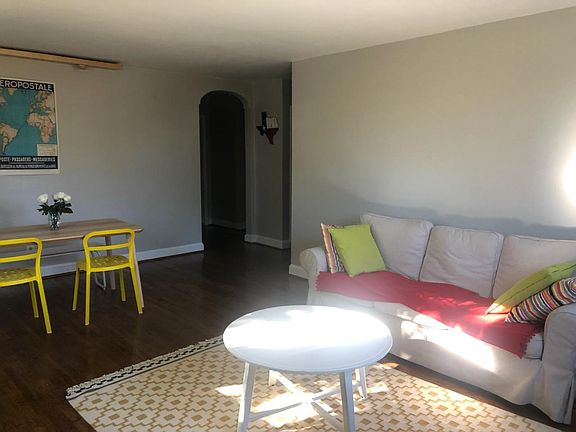 Bright and sunny living area with hardwood floors throughout.