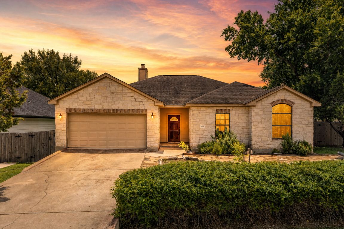 14900 Longbranch Dr at dusk.  Single story.  Corner lot.