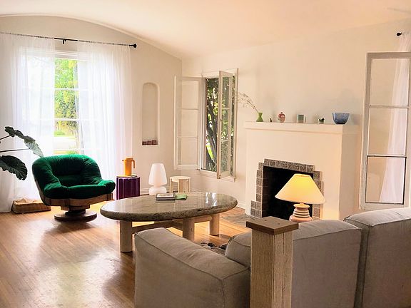 Extra large living room, arches, high ceiling, beautiful hardwood floors.