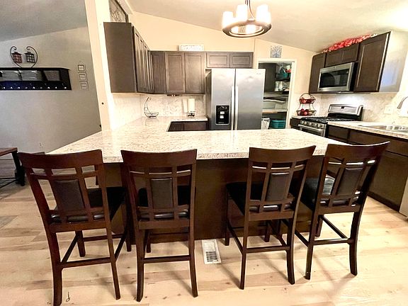 This kitchen is a chefs delight! Full size refrigerator, gas range, 3-level dishwasher and ample storage. The 4 seat eat in bar is a wonderful addition.