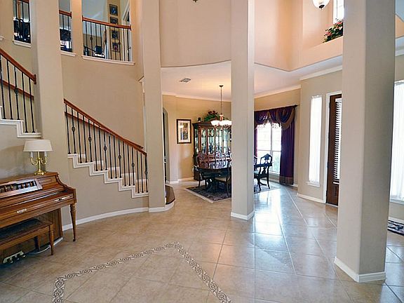 Grand rotunda two story entry with beautiful tiled floors with decorative accents.