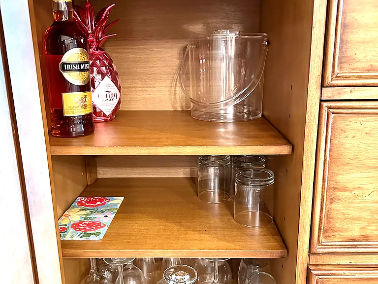 Details for the perfect pour. _ Whether it's a morning juice or an evening glass of wine, we have the perfect glass waiting for you. Our classy coastal bar cabinet is organized and ready to help you settle into "island time."