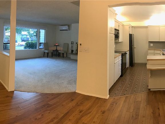 Front entry, living room and kitchen as seen from dining area.