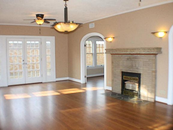 The front door leads to the vast living room which spans the width of the home. The French doors on 