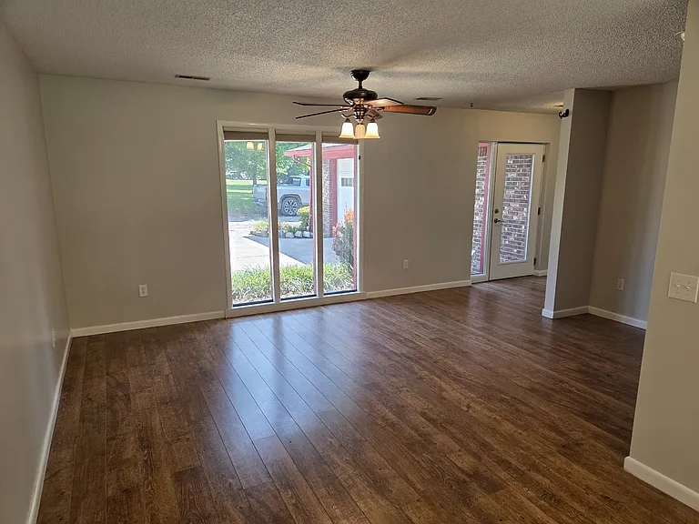 Living room looking out the front of the house and showing the entrance door to the right