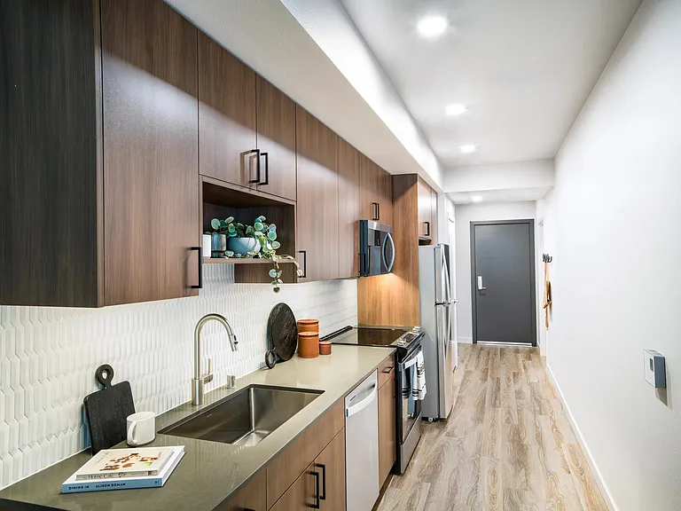 Modern cabinetry and sleek finishes make Modera Shoreline's kitchens both stylish and functional_perfect for cooking or casual dining at home.
