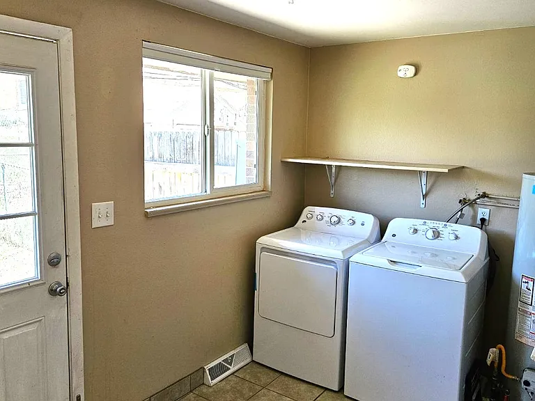 Laundry room with extra storage and shelves