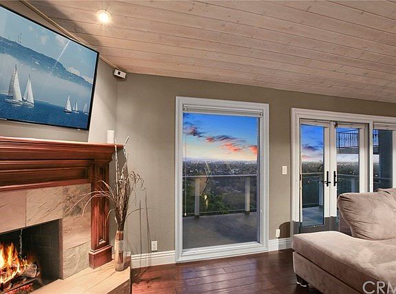 Gas fireplace in great room/family room with city lights/Catalina view
