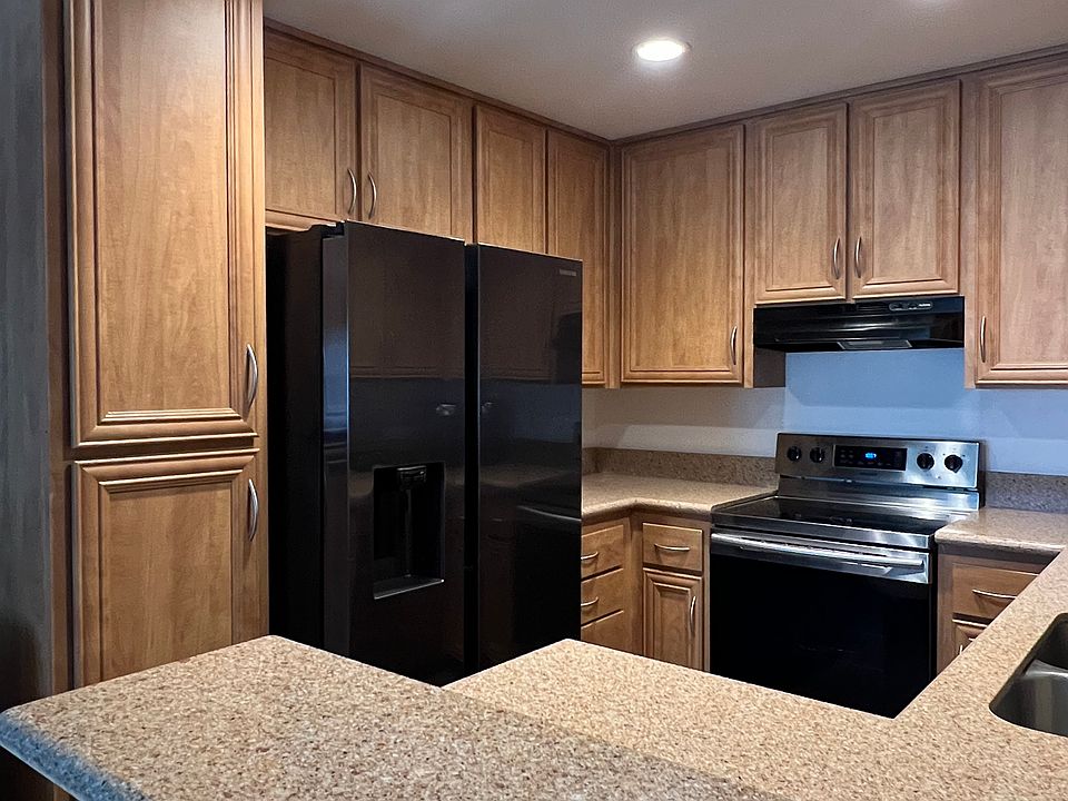 Kitchen with new refrigerator and stainless steel stove, dishwasher
