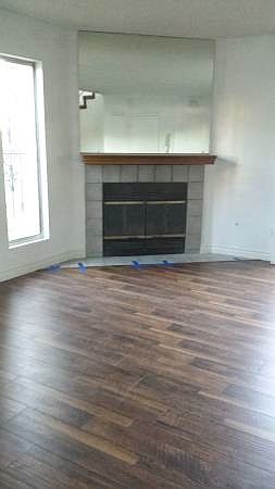 Brand new flooring in living room w/fireplace
