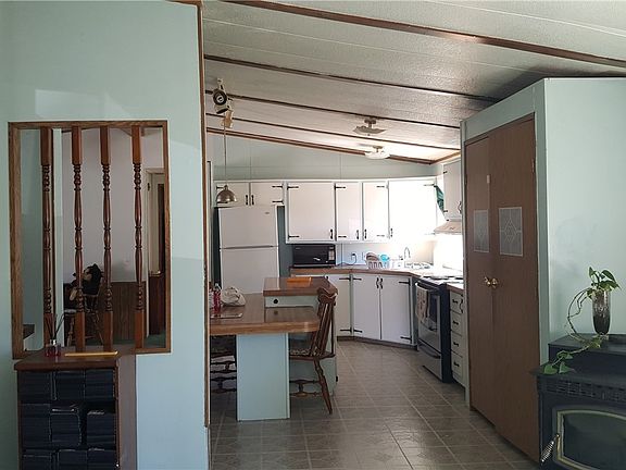 View of other side of kitchen. Pellet stove in living area. 