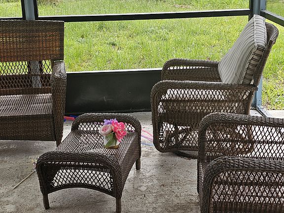 Have your 'good morning' coffee in your bug free, screened in backyard lounge area.