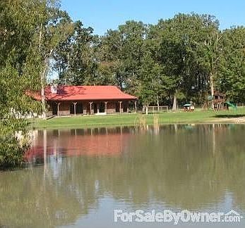 View of house and part of pond : The pond is in front of house and is much bigger than this picture 