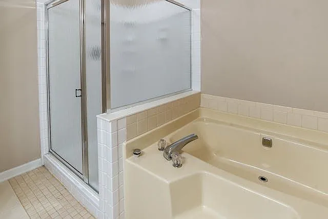 Ensuite bath has large walk in shower and step down garden tub