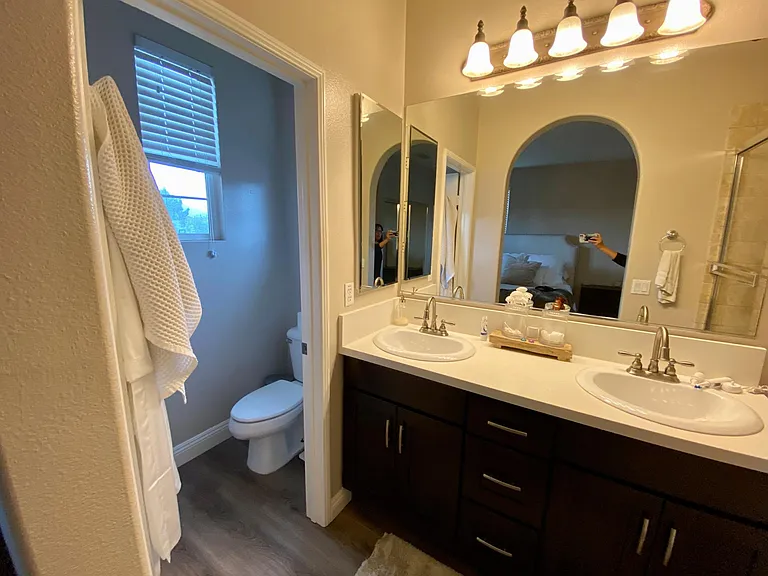 Master bathroom. The toilet is in its own room with a closing door and window!