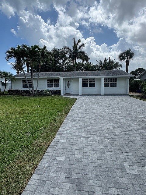 Shiplap Exterior with Brick Paver Driveway. Quite Intra-Coastal Street and large front yard.