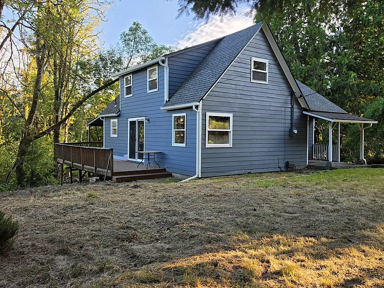 Front east side of house, deck showing sliding door into living room
