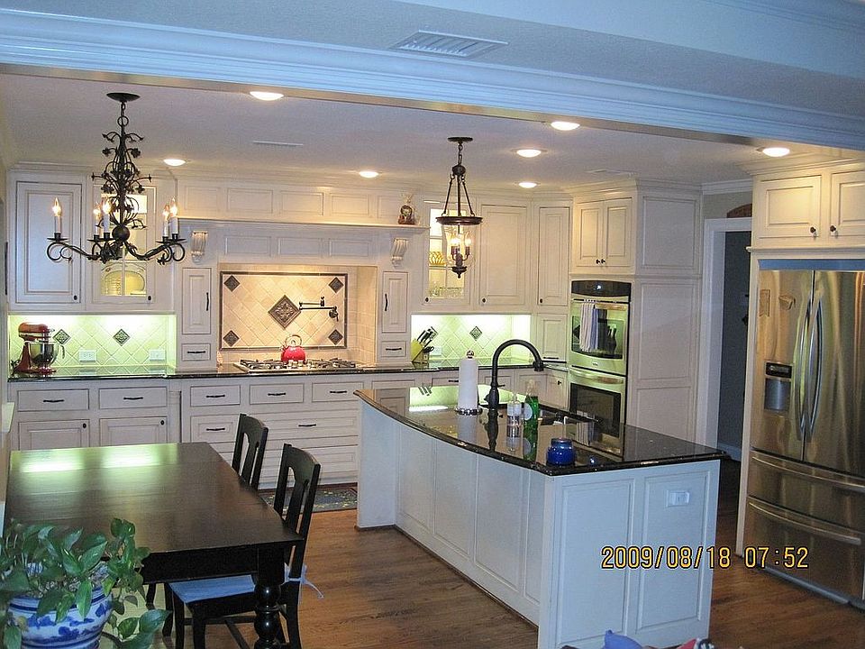Remodeled kitchen with granite, backsplash and potfiller