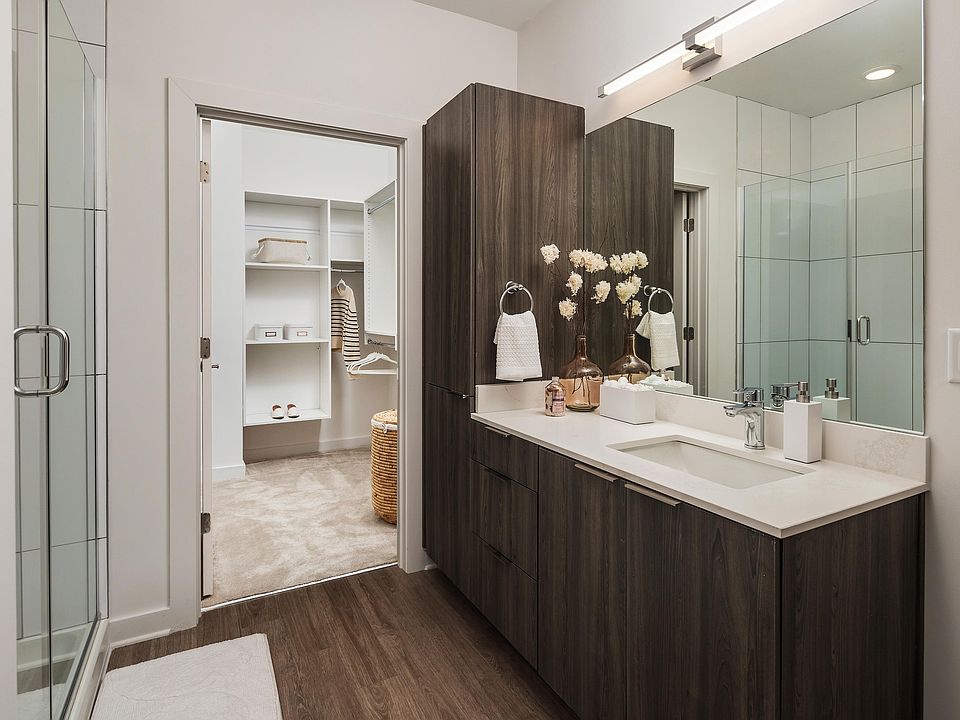 Experience the elegance of this modern bathroom paired with a generous walk-in closet for ultimate convenience.