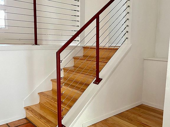 Foyer with stair case going up to the dining room and kitchen