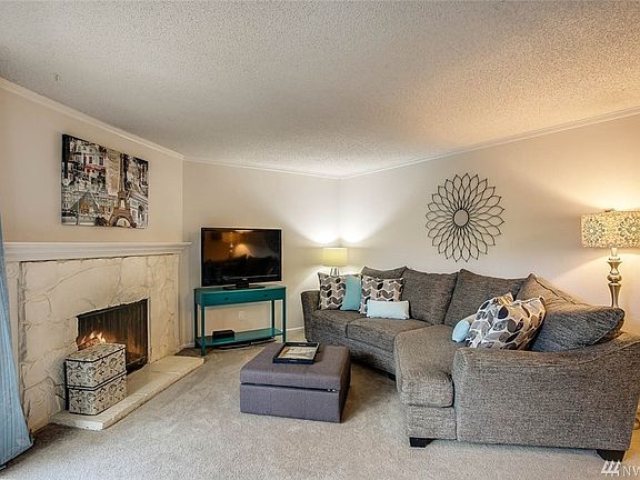 Spacious living room with wood burning fireplace.