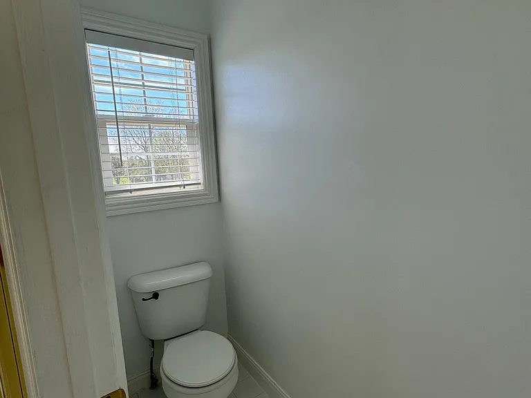 Master Bathroom Toilet is enclosed with a door