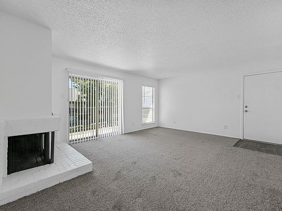 Spacious open floor plan with access to kitchen and fireplace with sliding door