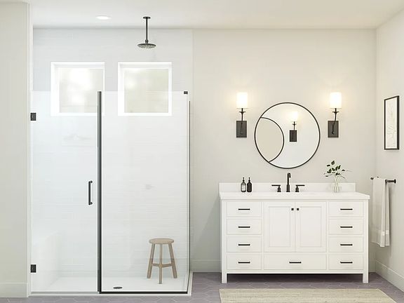 Primary bath with glass shower enclosure and matte black fixtures