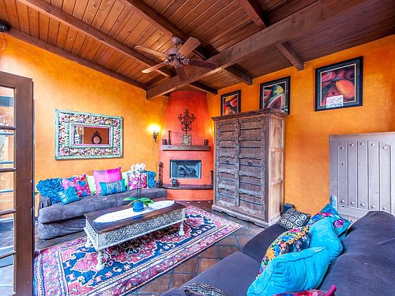 beautiful den/TV room w/ french doors that open to outdoor p