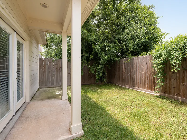 Private covered patio accessible through French doors from Bedroom 3.