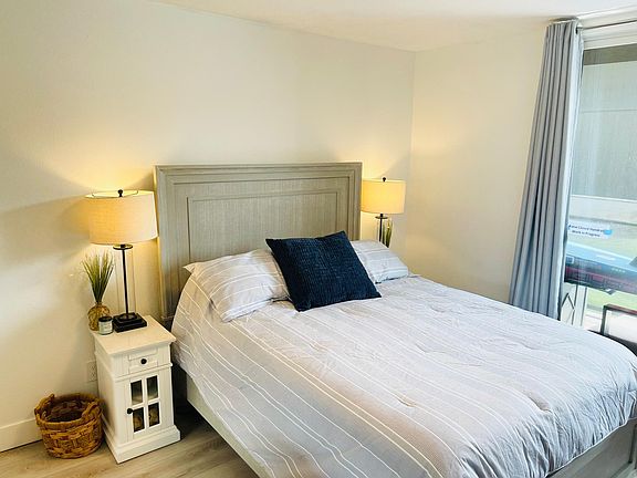Queen bed with a half bath and lake view