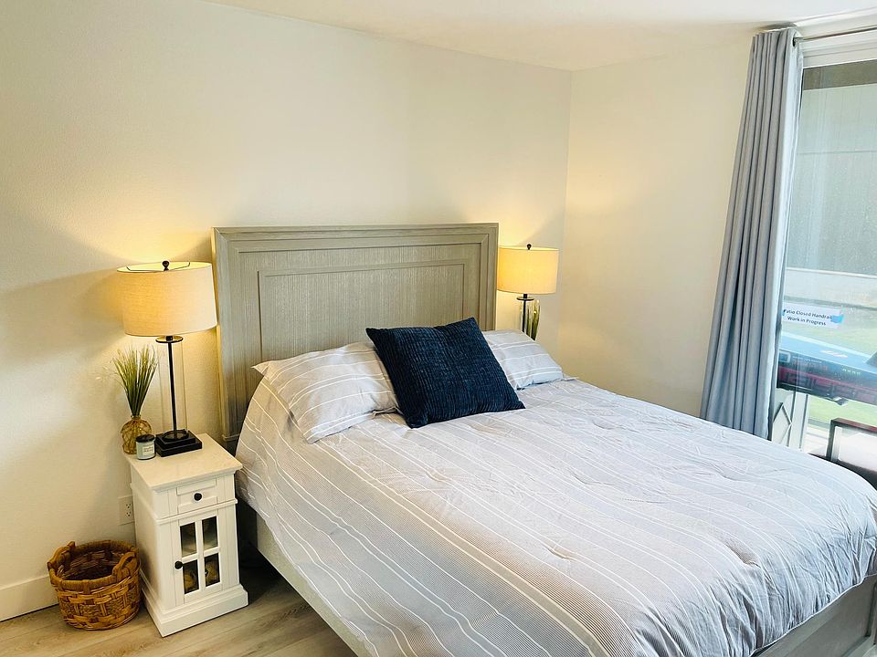 Queen bed with a half bath and lake view