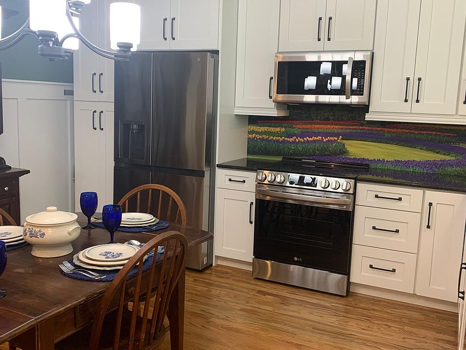 As you walk in the front door, on the right is your eat-in kitchen with a beautiful mural and under cabinet lighting.