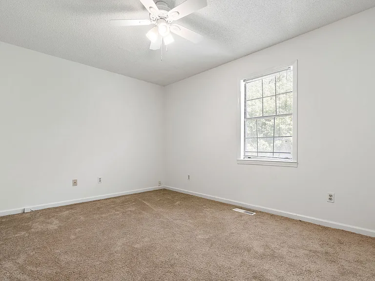 Second bedroom with bright natural light and ceiling fan _ great for guests, kids, or a home office