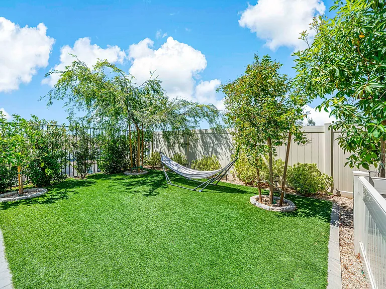 Low maintenance landscaping with synthetic grass in the front and backyard
