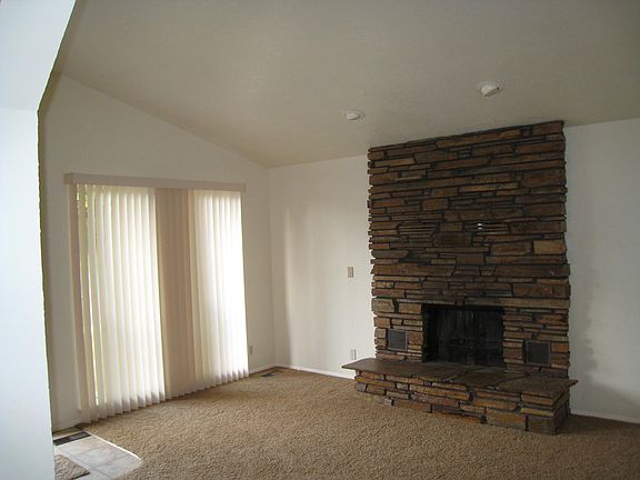 Living room with wood burning fireplace