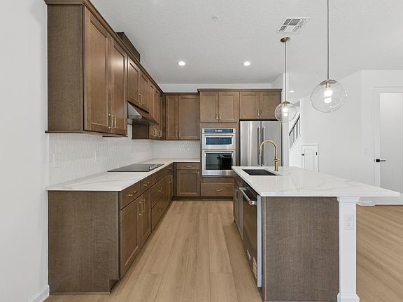 Gourmet kitchen boasting a large center island with quartz countertops