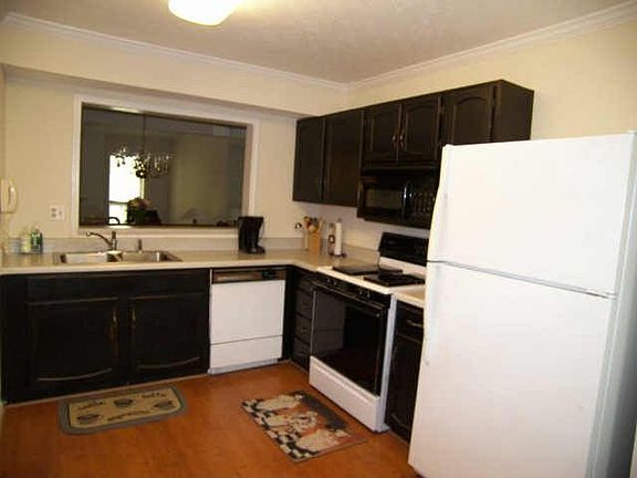 Kitchen has been updated with glazed cabinets and large breakfast area.