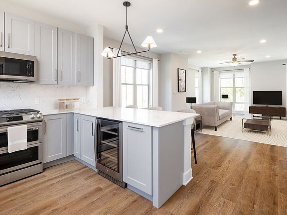 Signature Collection kitchen and living room with hard surface flooring