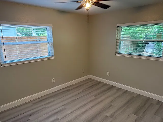 Bedroom 1, has two windows with plenty of light and privacy, opening up to the backyard