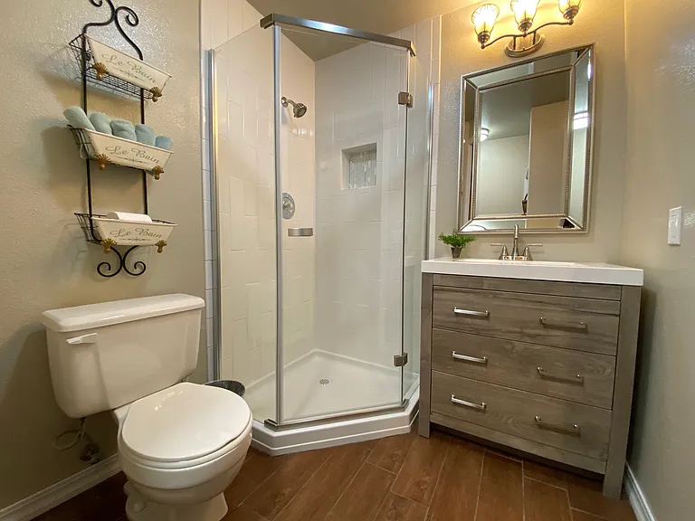 hallway bath with full sized stacked laundry