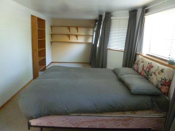 Master bedroom with windows that let in plenty of sunshine.